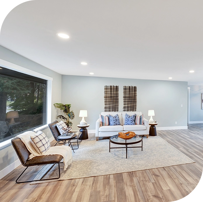 A living room with white walls and wooden floors.