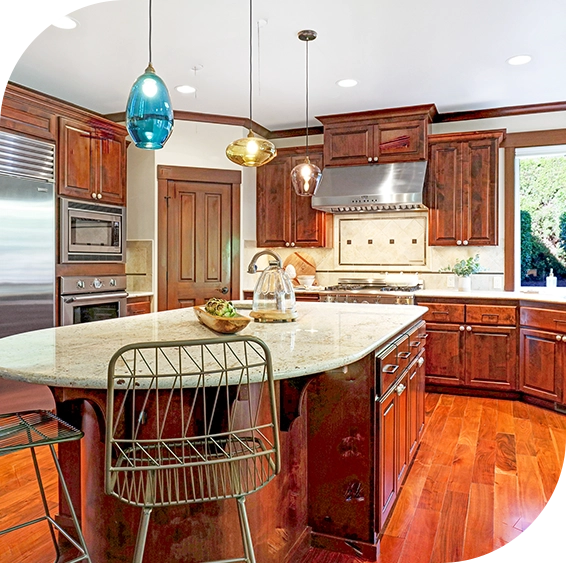 A kitchen with wooden floors and white counters.