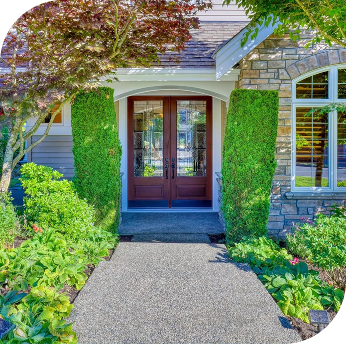 A house with two doors and bushes around it