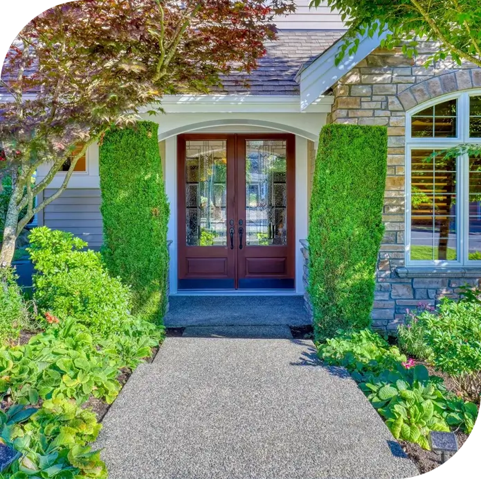 A house with two doors and bushes around it